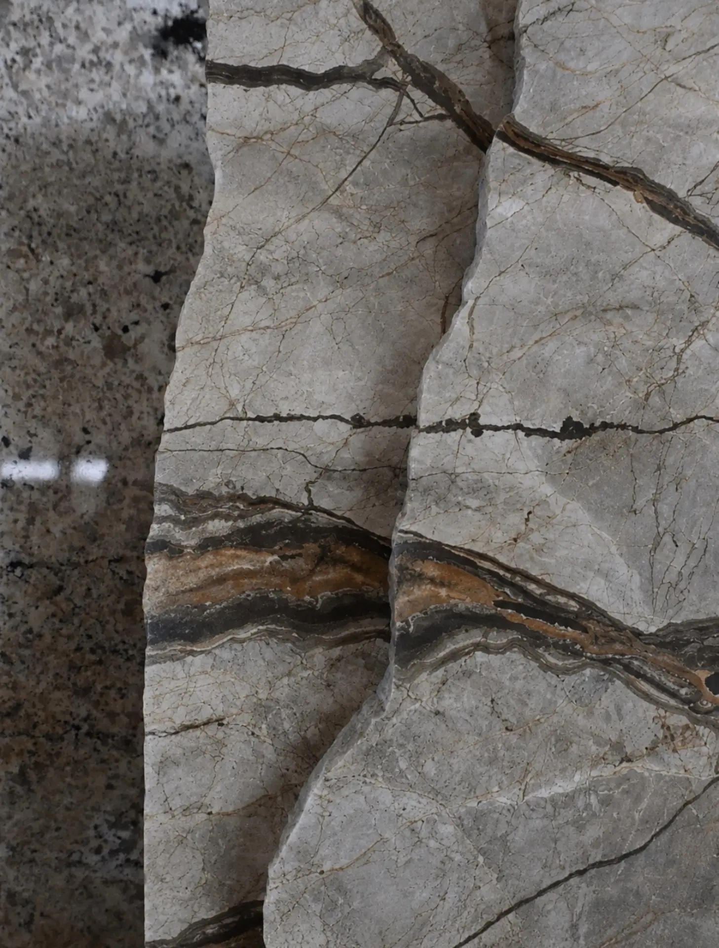 Grey stone slab detail with dark horizontal veining